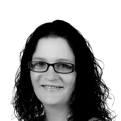 Black and white portrait of a woman with glasses.