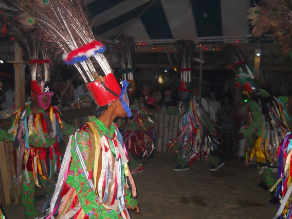 Ritual dance with colorful costumes and feathered headdresses.