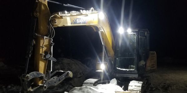 Excavator operating in winter and snowy conditions