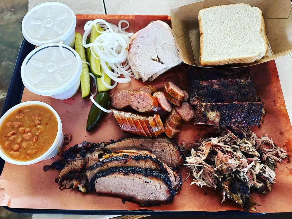 BBQ plate with smoked turkey, sausage, rigs, brisket and pulled pork and all the fixin's