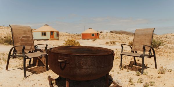 Kettle fire pit and seating near Sage and Cinnabar yurts