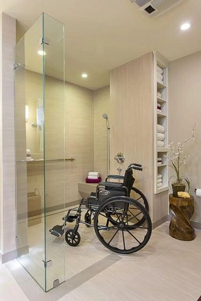 Accessible bathroom with wheelchair and modern design.