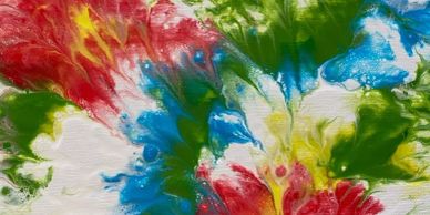 Abstract colorful paint splashes in red, blue, green, and yellow.