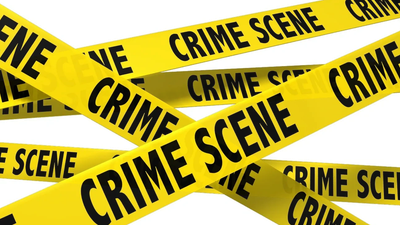 Crime scene tape warning people of car dealership crimes. 