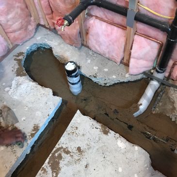 Bathroom Remodel concrete busted out to move toilet drain.  Pipes installed with foam wrap 