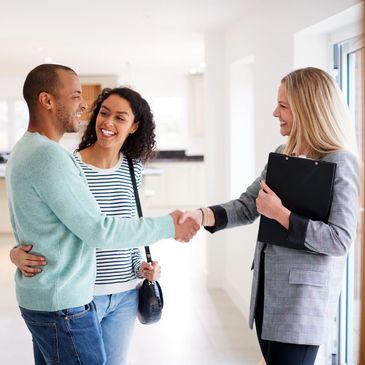 Women realtor with clients in home