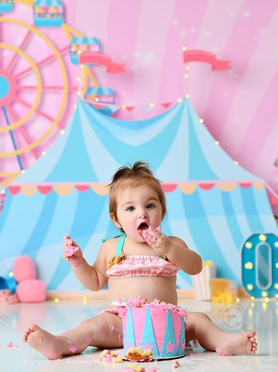 1 Year Birthday Cake Smash Session. Pastel Pink and Blue Circus Theme. Baby Girl eating her cake.
