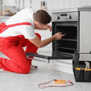 Appliance Repair Service Technician Repairing a residential oven. Oven Repair in California. 