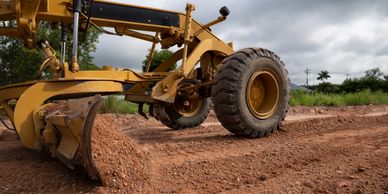 Dirt from Drive Way & Roads being scrapped off with dirt work equipment