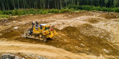 A bull dozer engaged in land clearing