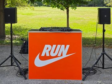 DJ booth with 'RUN' and Nike-style logo.