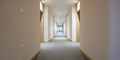 A hotel hallway covered in carpet by El Niño Floors