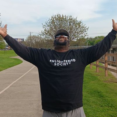 a man wearing Enlightened Society t shirt 