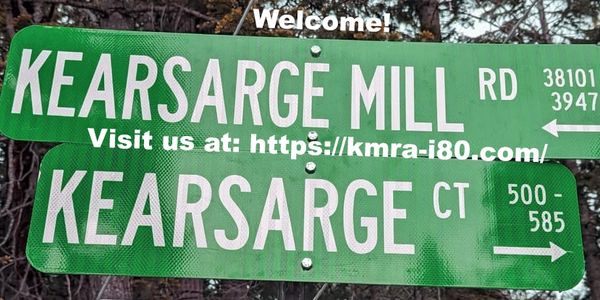 Green street signs for Kearsarge Mill Road and Kearsarge Court with directional arrows.