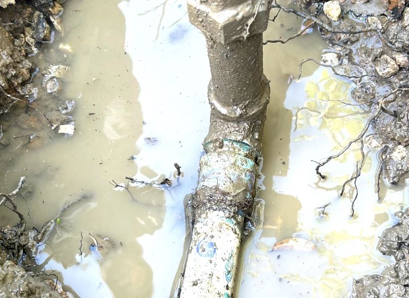 pipe leak outdoor in muddy leaking water