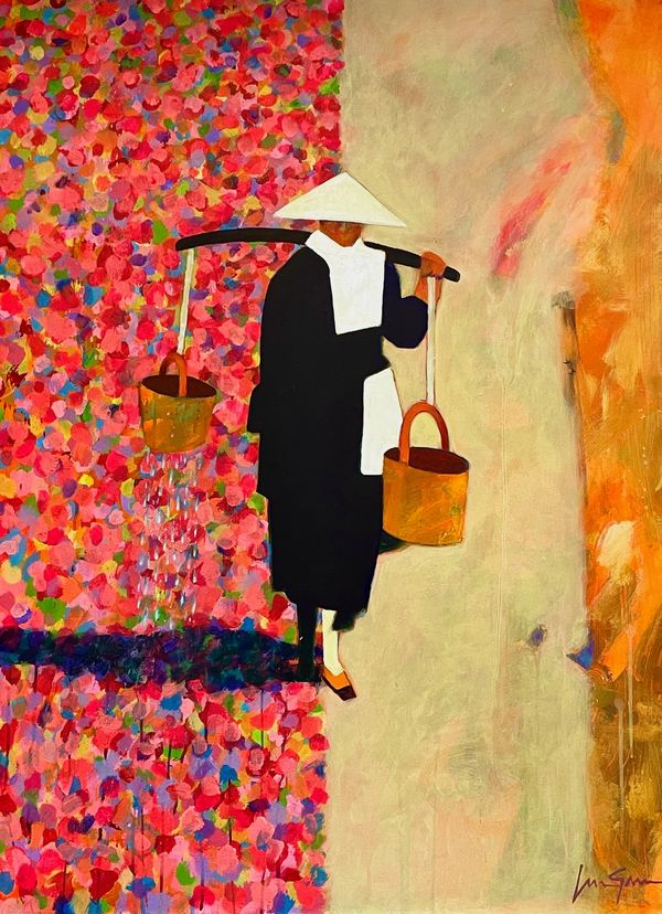 Asian woman with water buckets walking  a path with colorful flowers on one side & dirt on the other