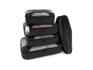 Set of black packing cubes and a shoe bag for organized travel.