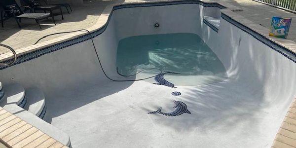 Swimming pool being refilled after remodeled.