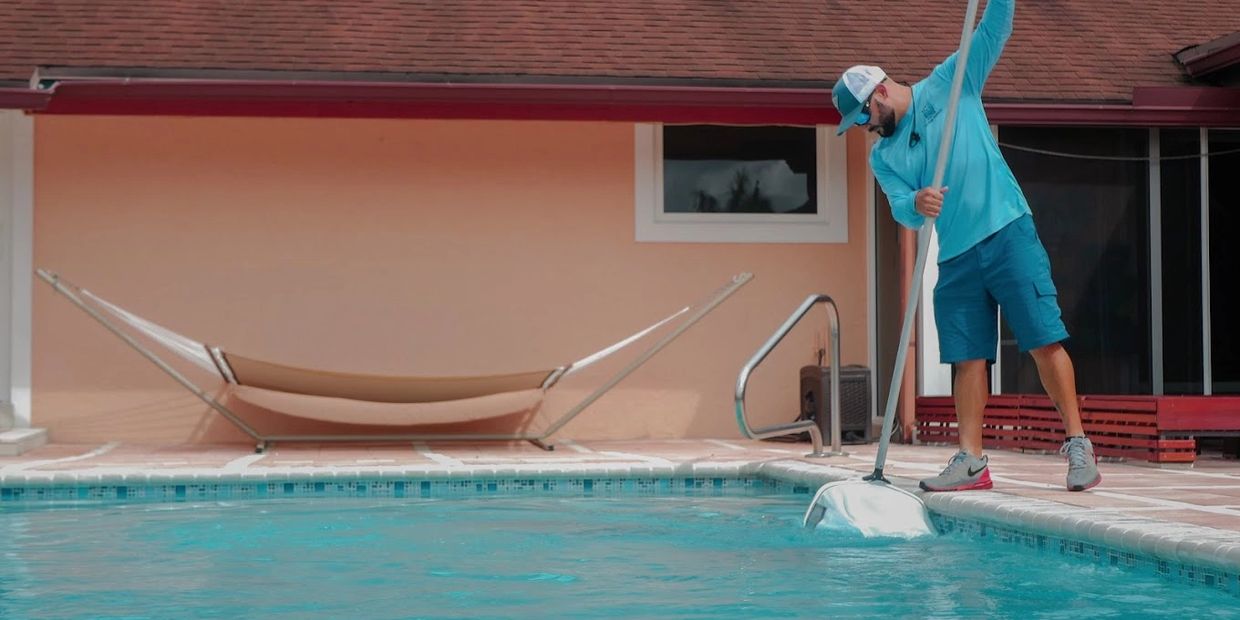 Pool tech cleaning and serving a pool.