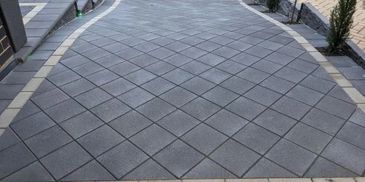 charcoal concrete driveway pavers laid in a diamond pattern, paving features header coarse pattern