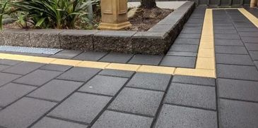 brick sized pavers with a border, charcoal coloured pavers, paving and garden bed in Golden Grove 