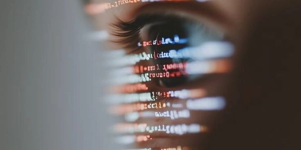 Close-up of an eye reflecting computer code.