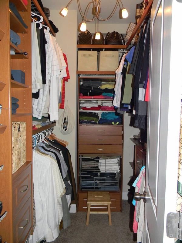 A close-up of the clothes in the wooden closet 