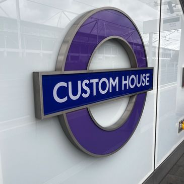 Custom House station sign with purple roundel.