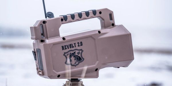 Portable Revolt 2.0 device with handle and antenna in snowy environment.