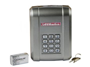 A LifeMaster keypad lockbox with keys and a pack of Ultralife batteries.