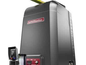 Black LiftMaster gate opener with control panel and sensors.