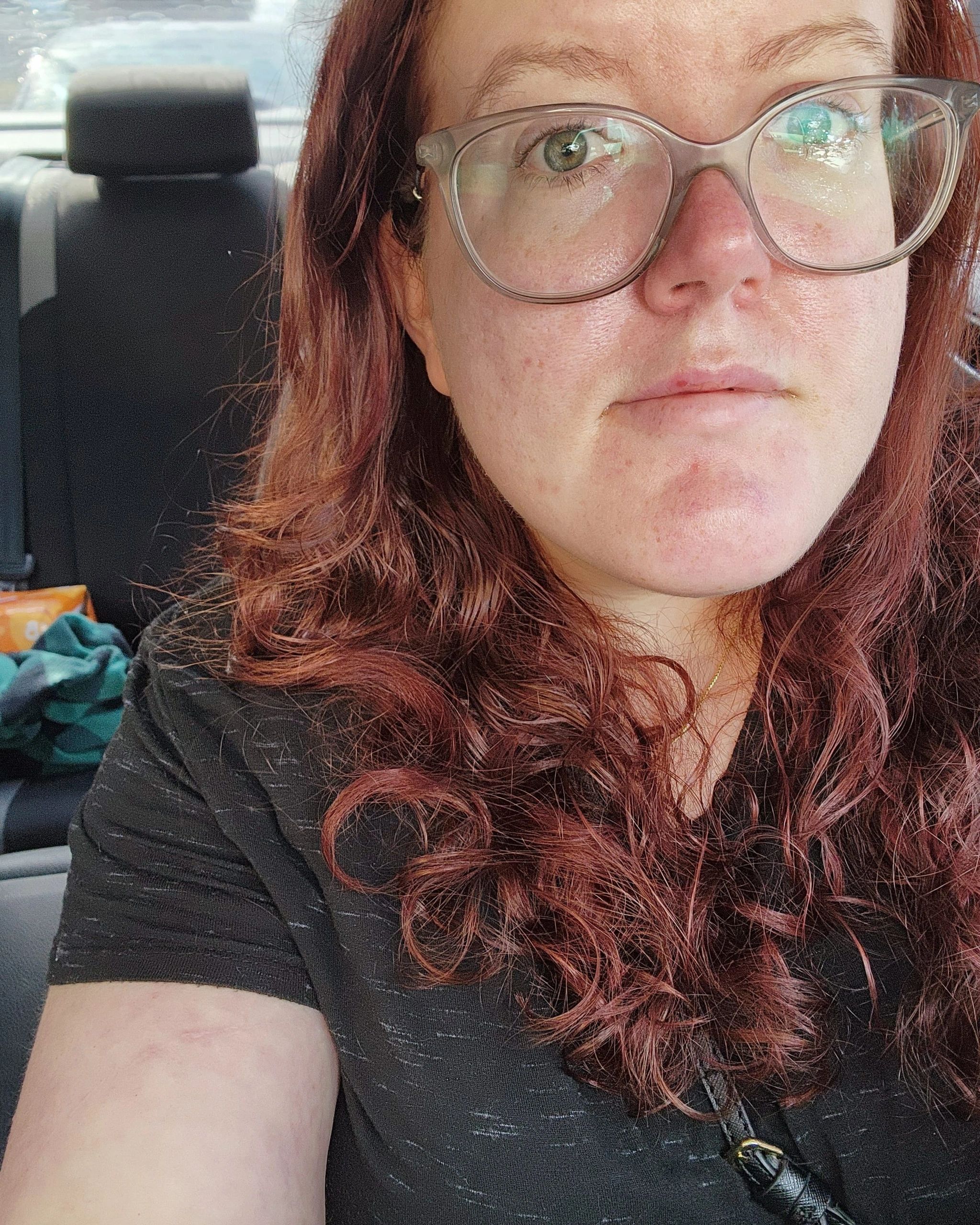 Picture of a woman with red hair looking at the camera