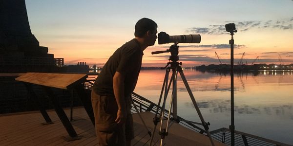 A camera operator during sunrise in Philadelphia.