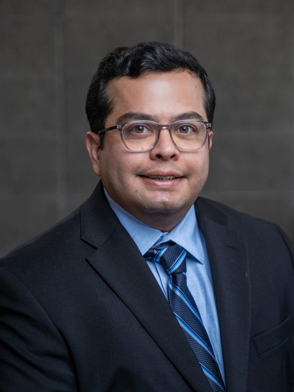 Professional man in a suit and tie with glasses.