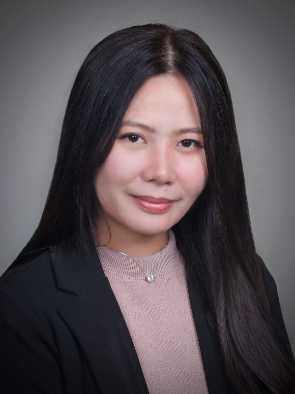 Portrait of a woman with long black hair and a black blazer.