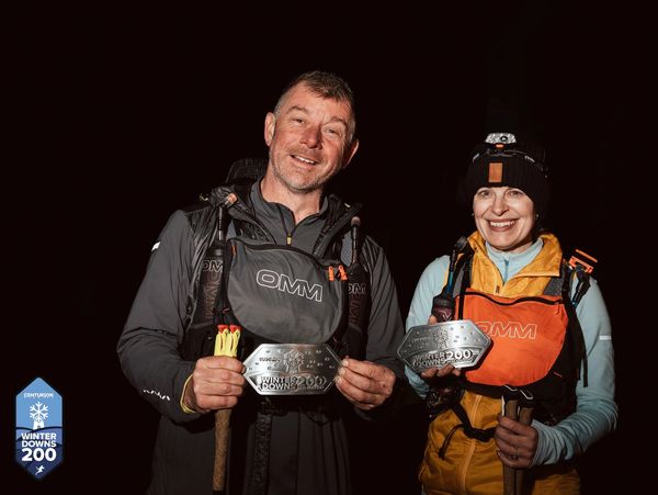 Two hikers show their Winter Downs 200 awards with smiles.