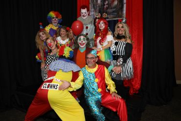 Group of people dressed as clowns for a party.