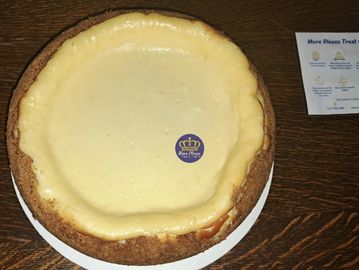 Plain cheesecake sitting on a table