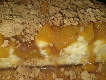 A close up of our gourmet peach cobbler cheesecake.