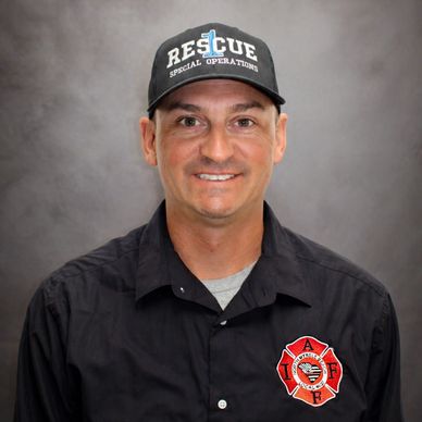 Man wearing a Rescue Special Operations cap and firefighter shirt.