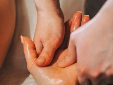 Close-up of a hand massage with warm oil.
