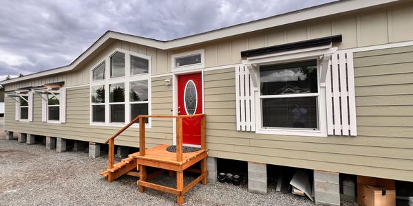 Exterior of mobile home with red front door