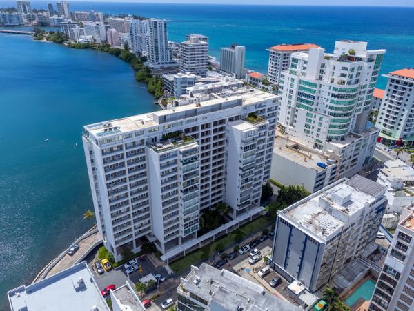 Coastal cityscape with high-rise buildings by the blue ocean and lagoon.