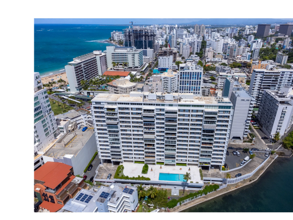 Aerial view of a coastal city with high-rise buildings and a swimming pool.