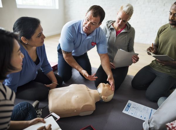 a CPR instructor teaching people about CPR