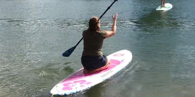 Woman kneeling on a paddle board