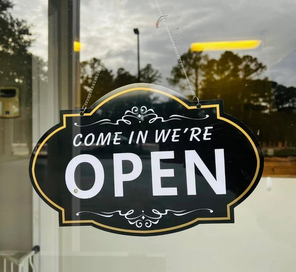 Come In We're Open sign in the DayCare window