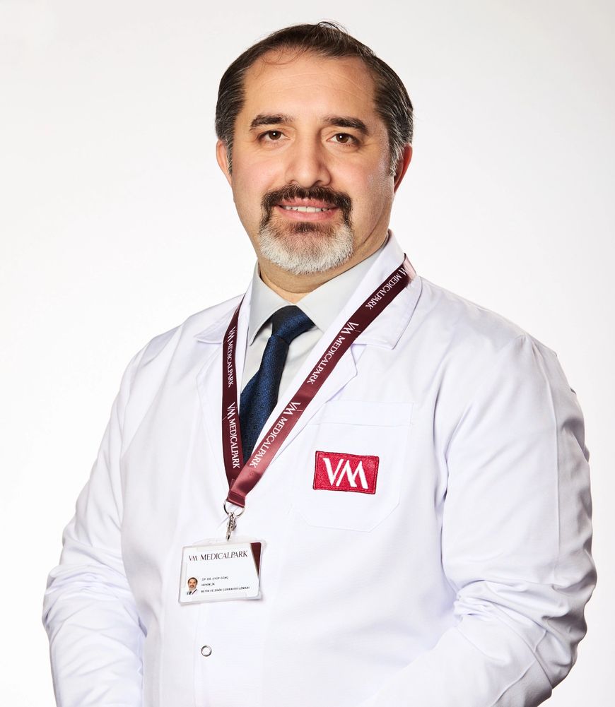 Stack of books next to pencils in a holder and a camera.