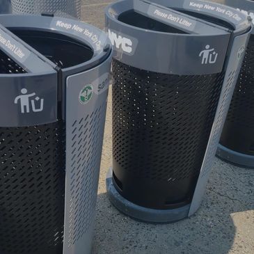 Modern NYC trash bins with 'Keep New York City Clean' message.
