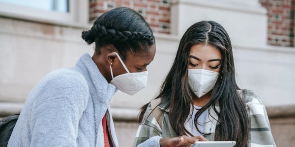 Two students working together on a tablet